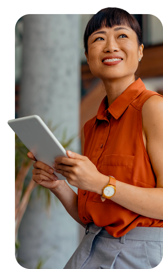 Smiling woman holding a tablet and looking upward, capturing a sense of progress, optimism, and personal momentum